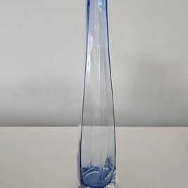 Clear glass vase with blue accent on a white background