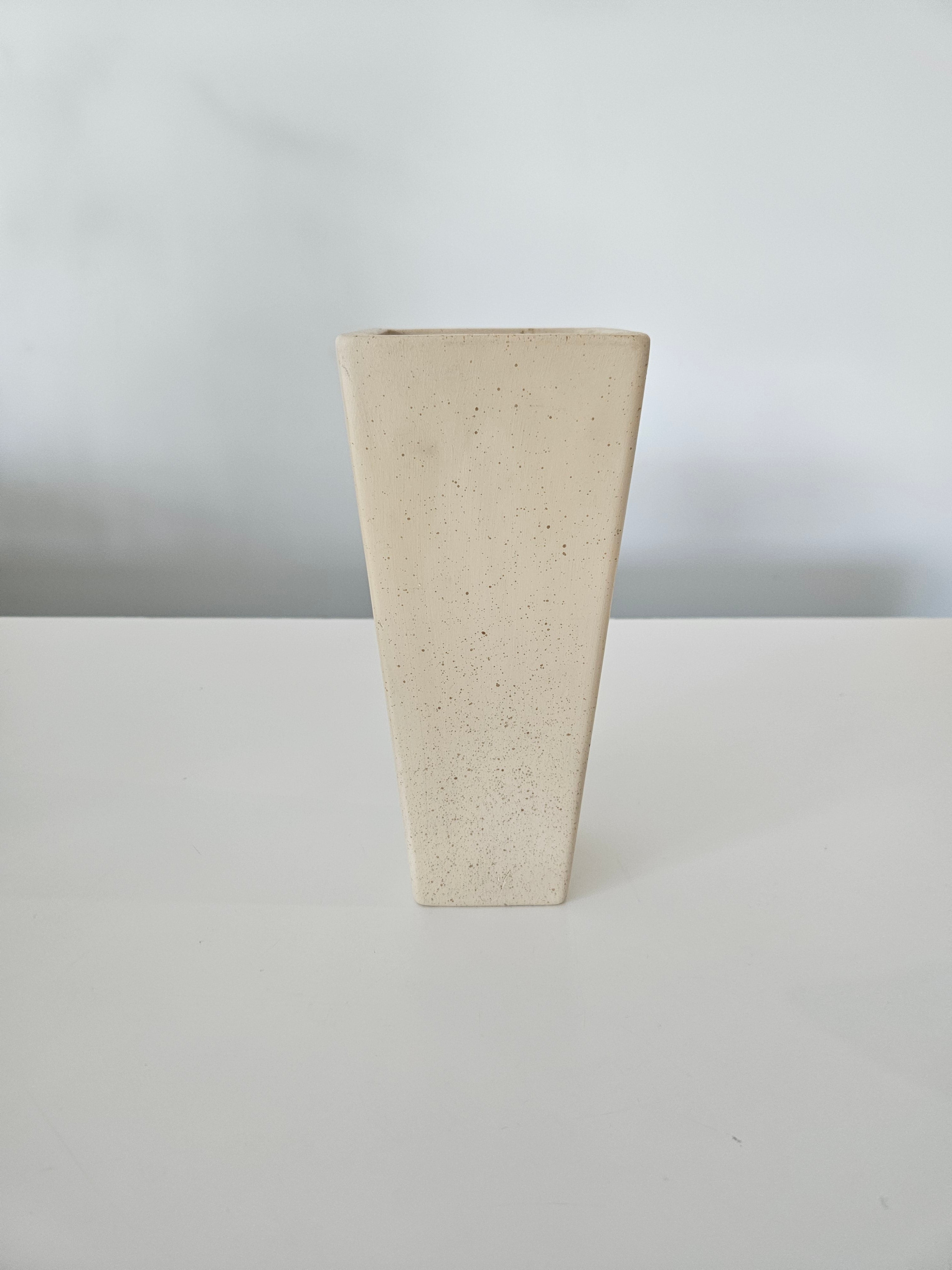 Rectangular beige stone vase on a white background