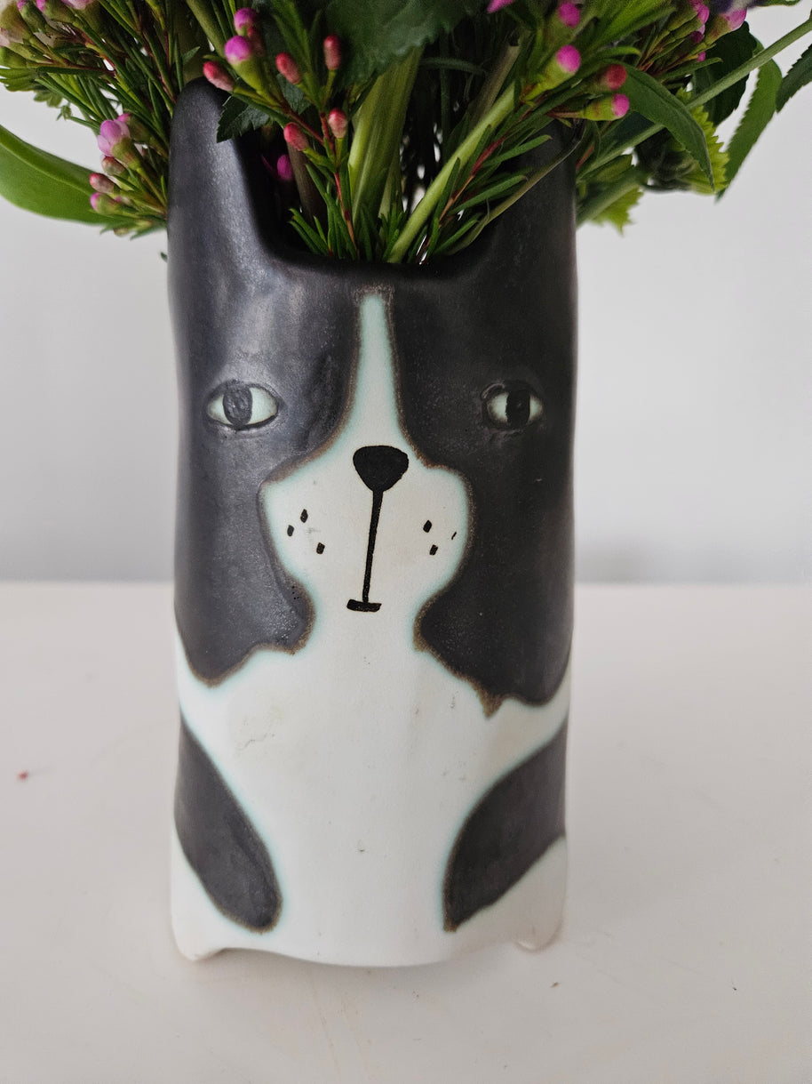 Ceramic planter with a dog's face on a white background