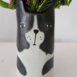 Ceramic planter with a dog's face on a white background
