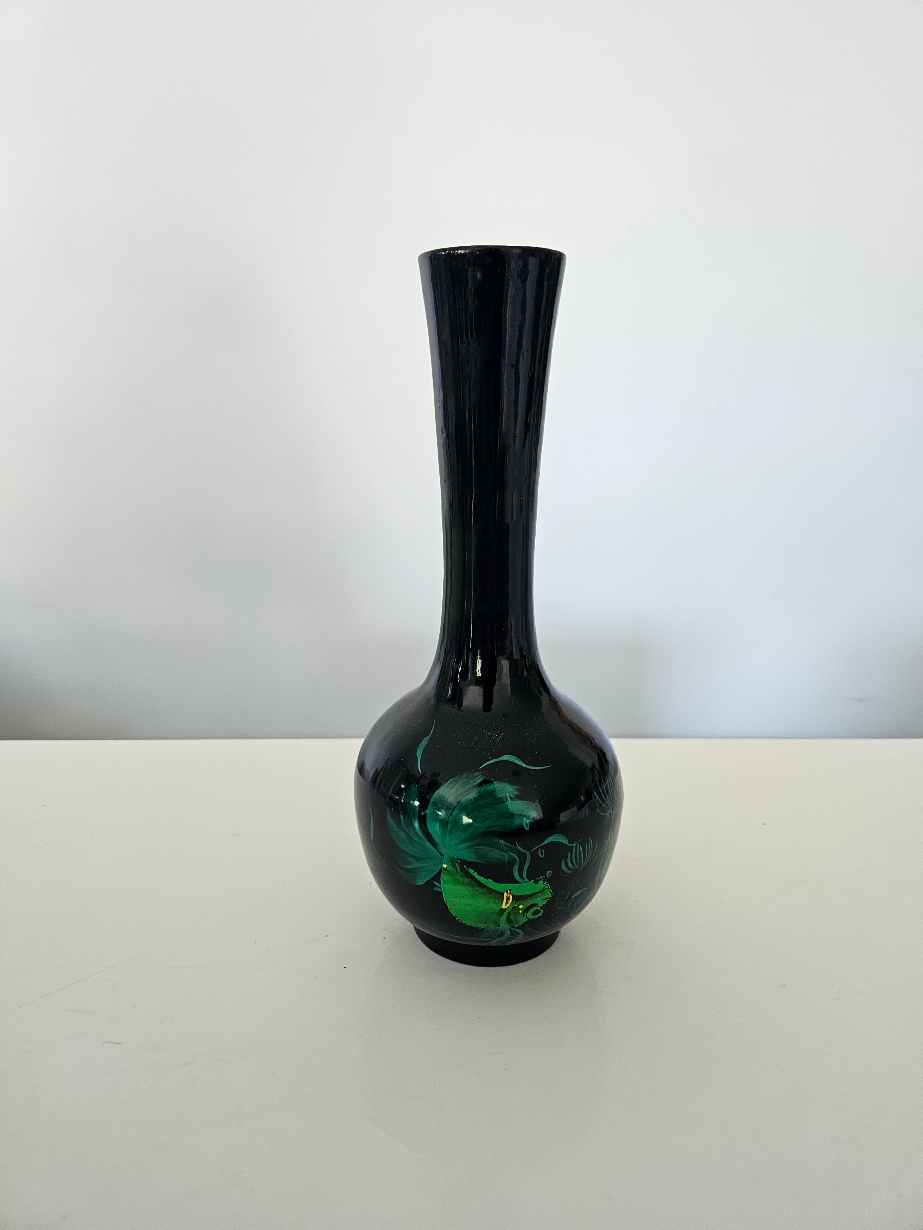 Black vase with floral design on a white background