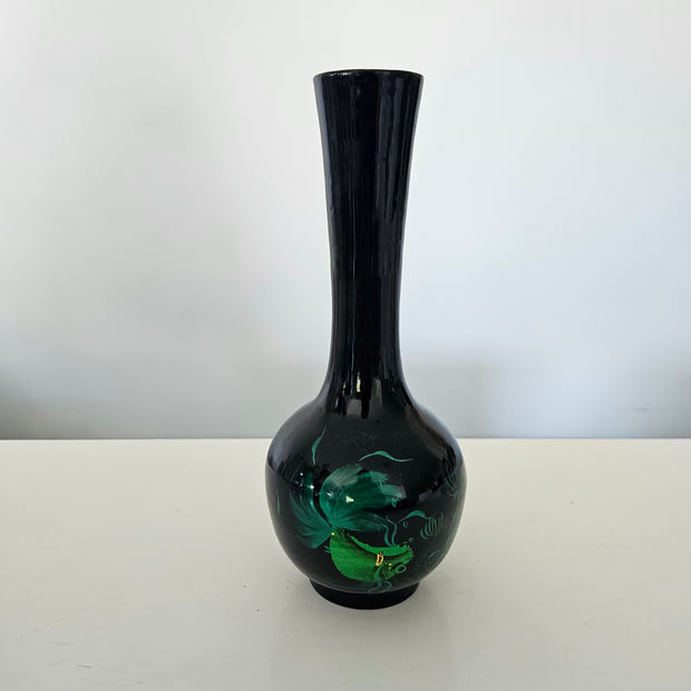 Black vase with floral design on a white background
