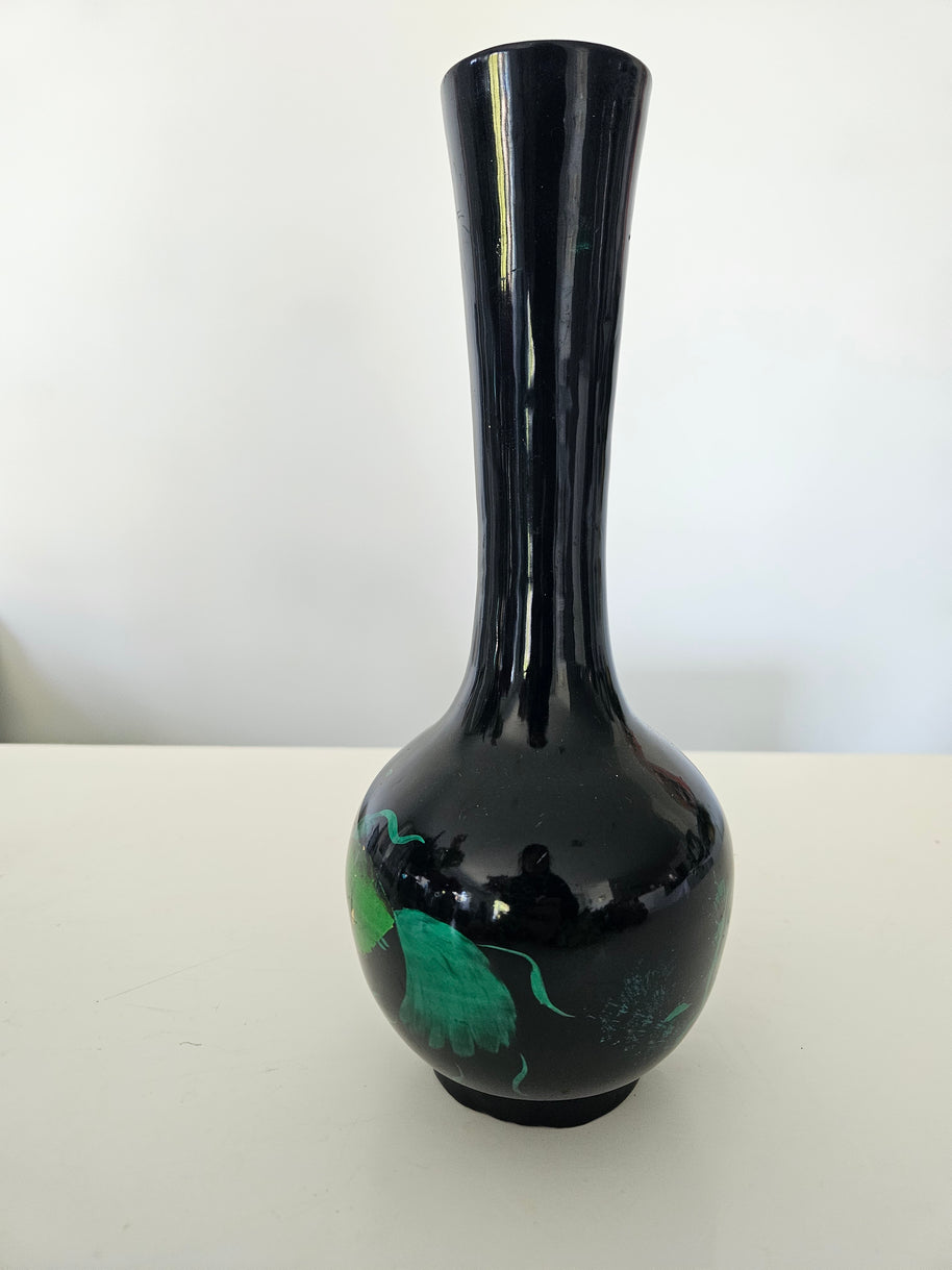 Black ceramic vase with green interior on a white background