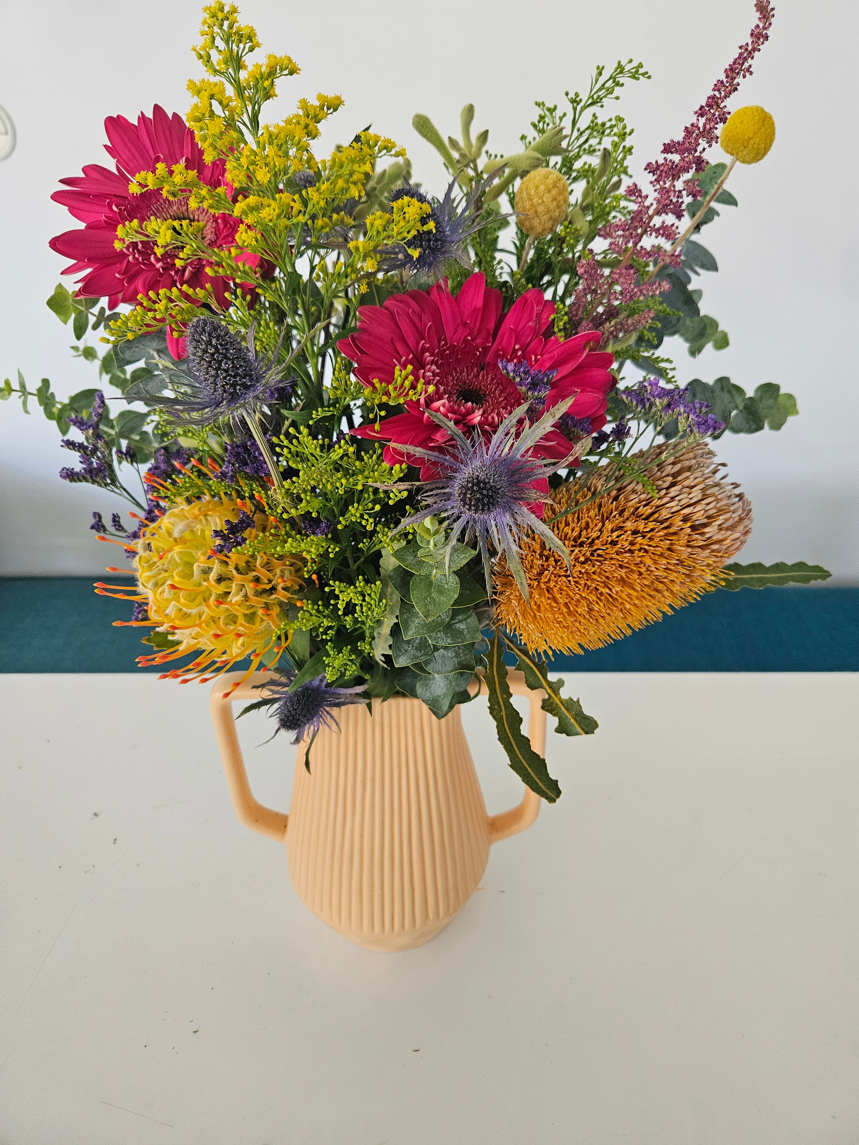 Light orange handled vase arrangement