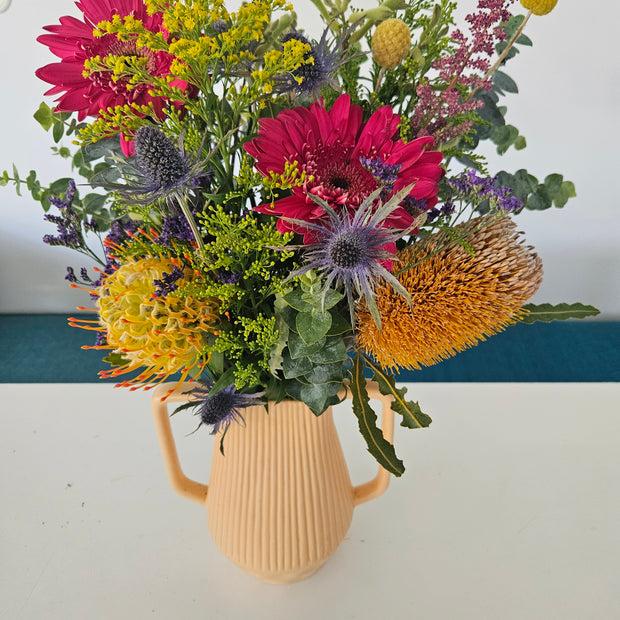 Light orange handled vase arrangement