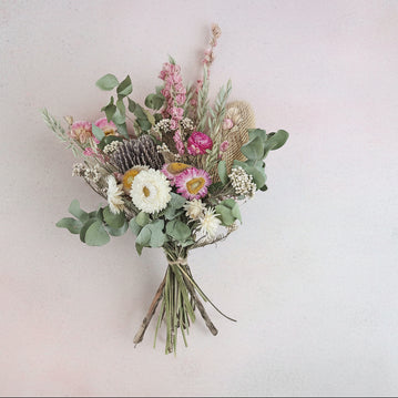 Bouquet of dried flowers on a textured surface
