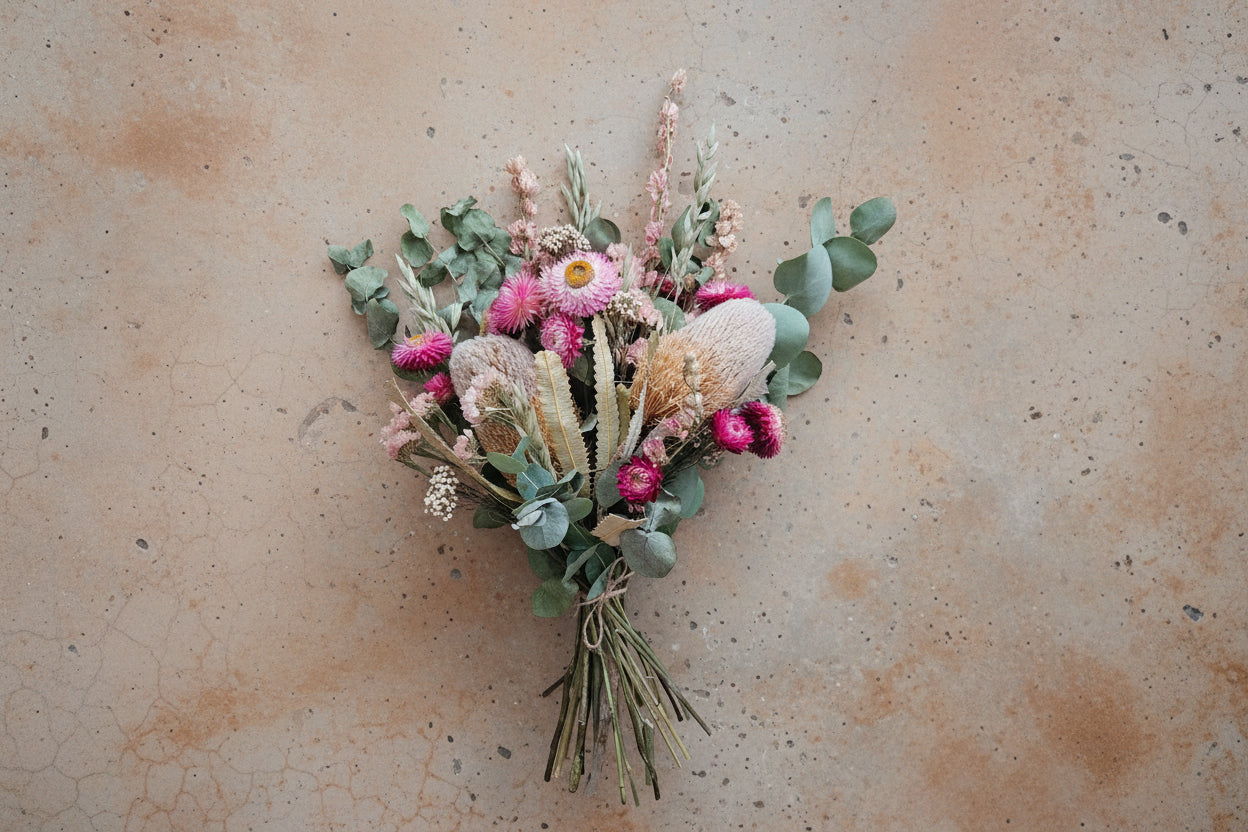 Bouquet of dried flowers and greenery on a beige background