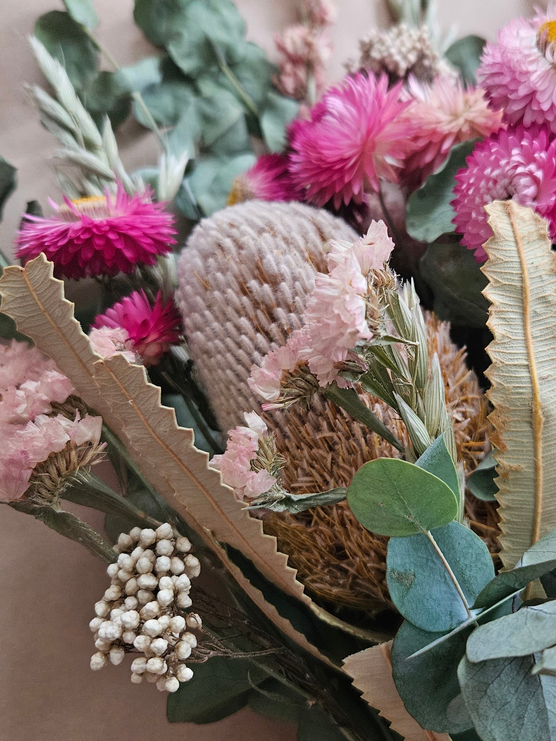 Banksia, statice, strawflowers and eucalyptus in a bouquet