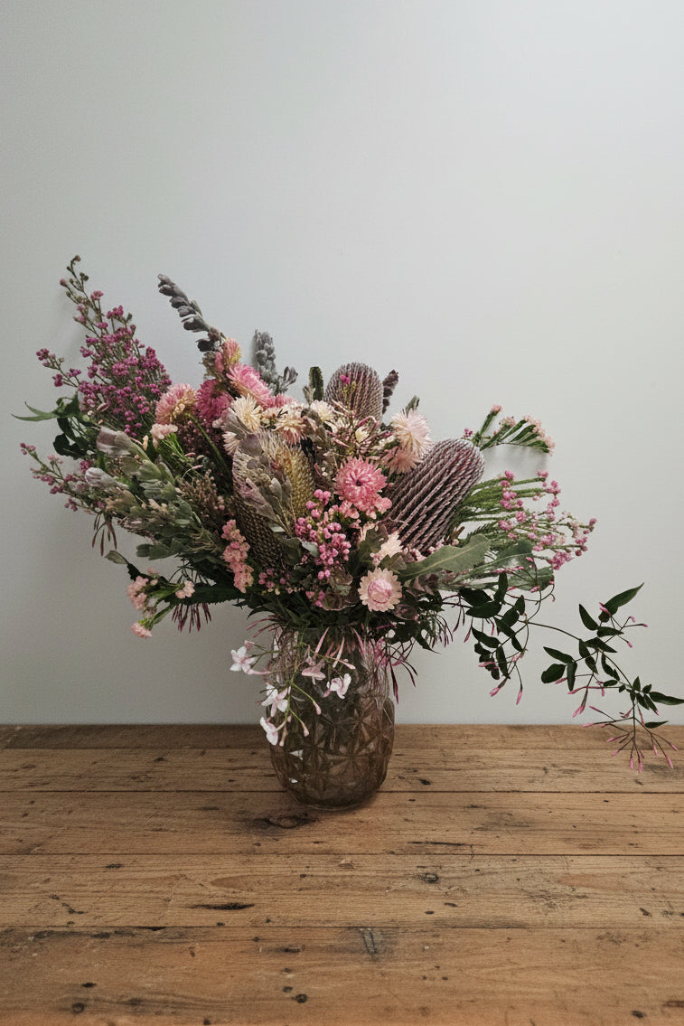 Fresh flower arrangement on a timber table