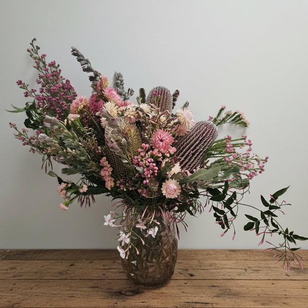 Fresh flower arrangement on a timber table