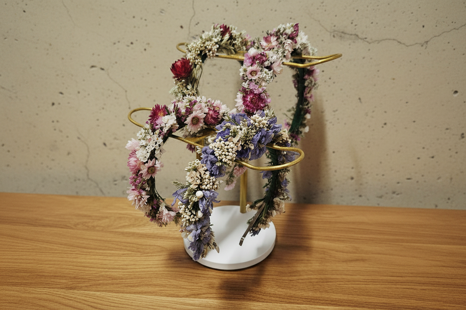 dried floral headbands on a stand on a timber table