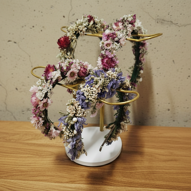 dried floral headbands on a stand on a timber table
