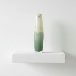 Tall ceramic vase with gradient design on a white background