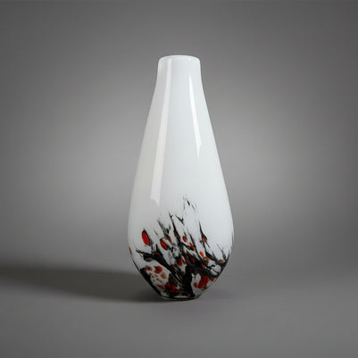 White vase with black and orange abstract design on a white background