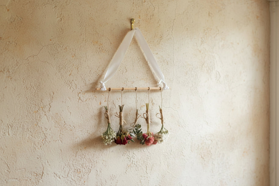 Hanging dried flowers on a soft cream wall