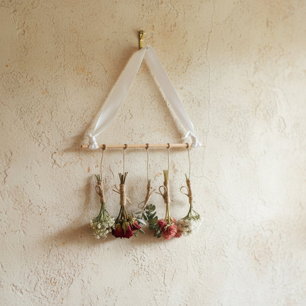 Hanging dried flowers on a soft cream wall