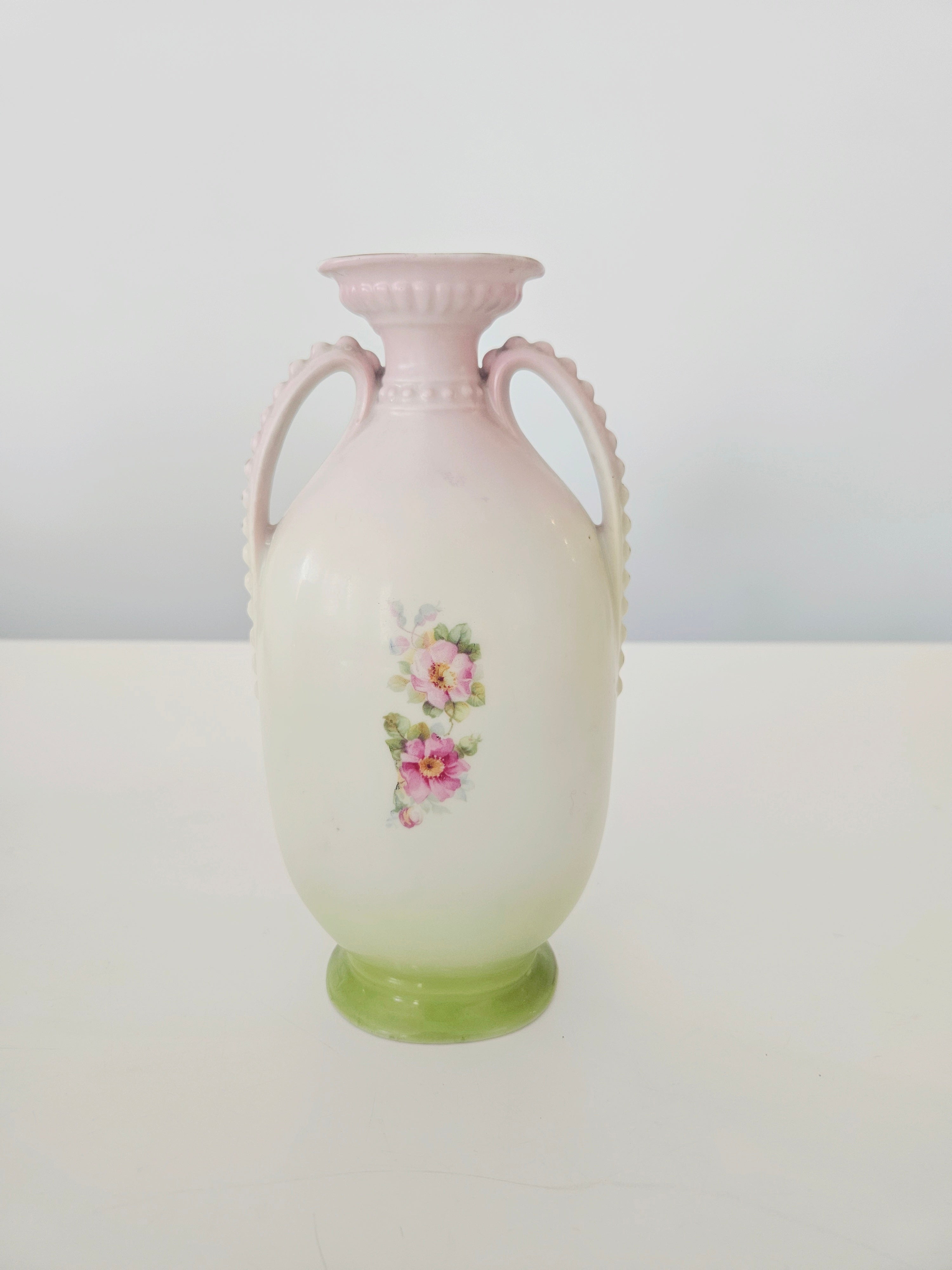 Decorative vase with floral design on a white background