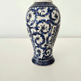 Ceramic vintage vase with blue and white floral patterns on a white background