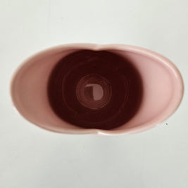 Close-up of a pink ceramic cup on a white background