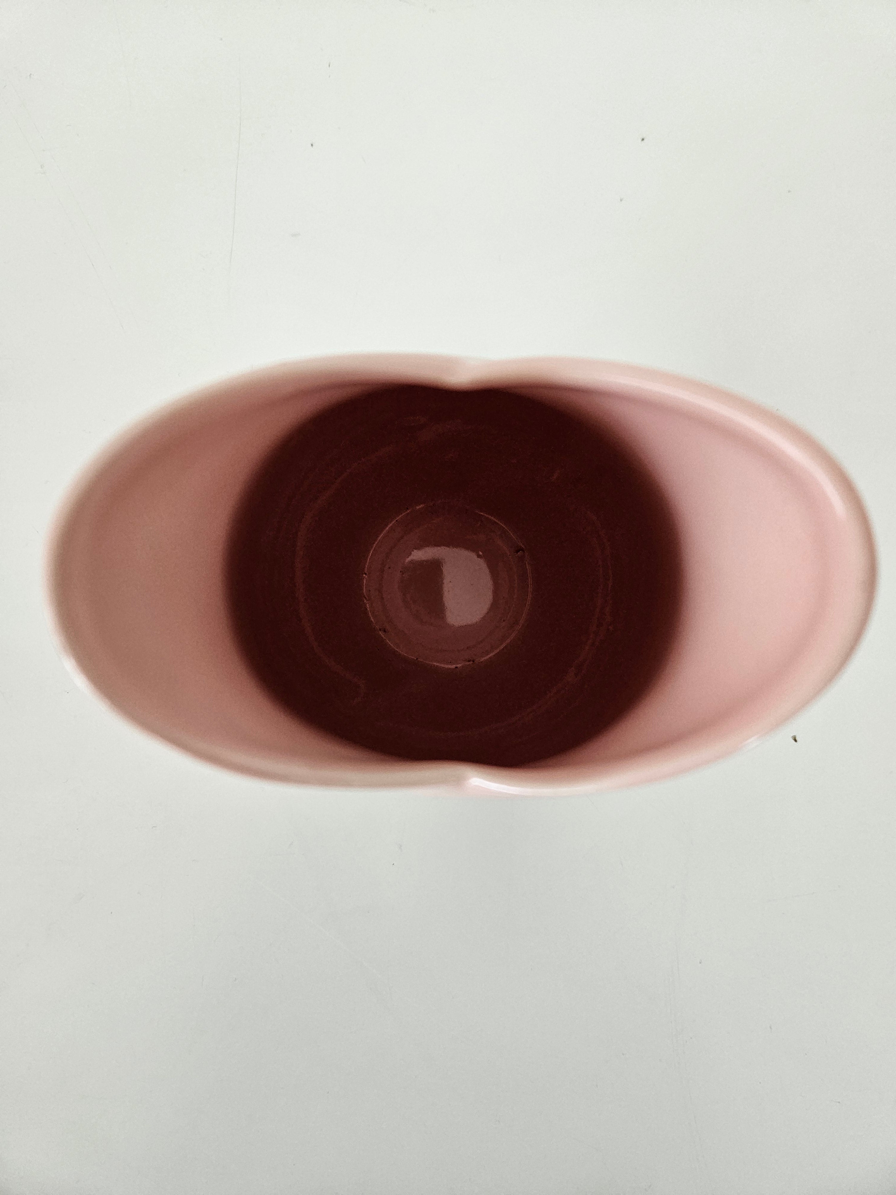 Close-up of a pink ceramic cup on a white background