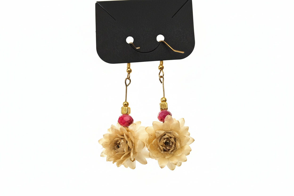 Floral earrings with gold and red accents on a white background