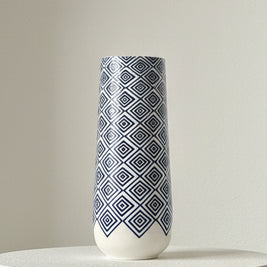 blue and white vase on a table