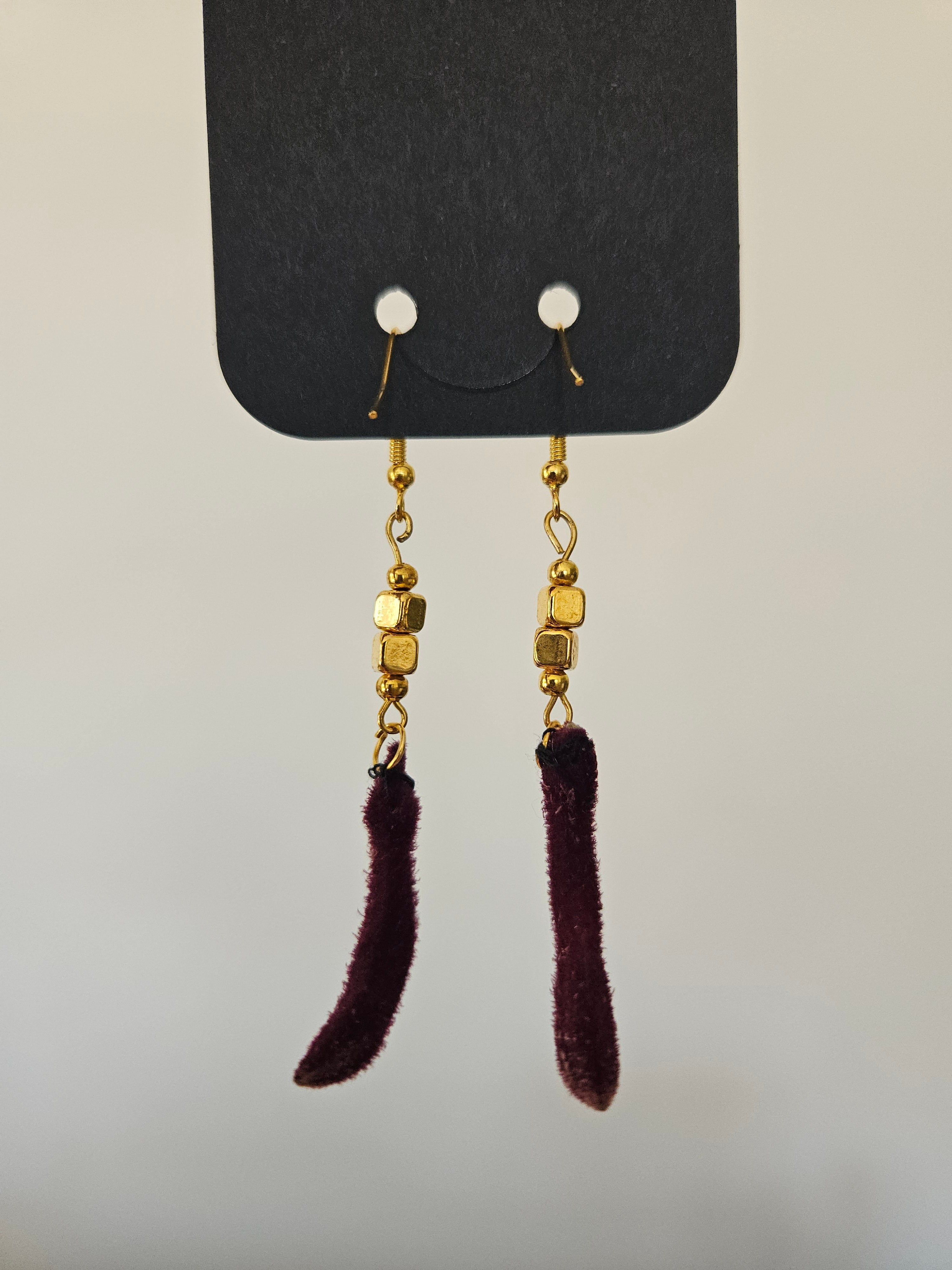 pair of gold earrings made from kangaroo paw