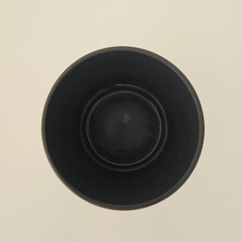 Top down view of a black pot on a white background